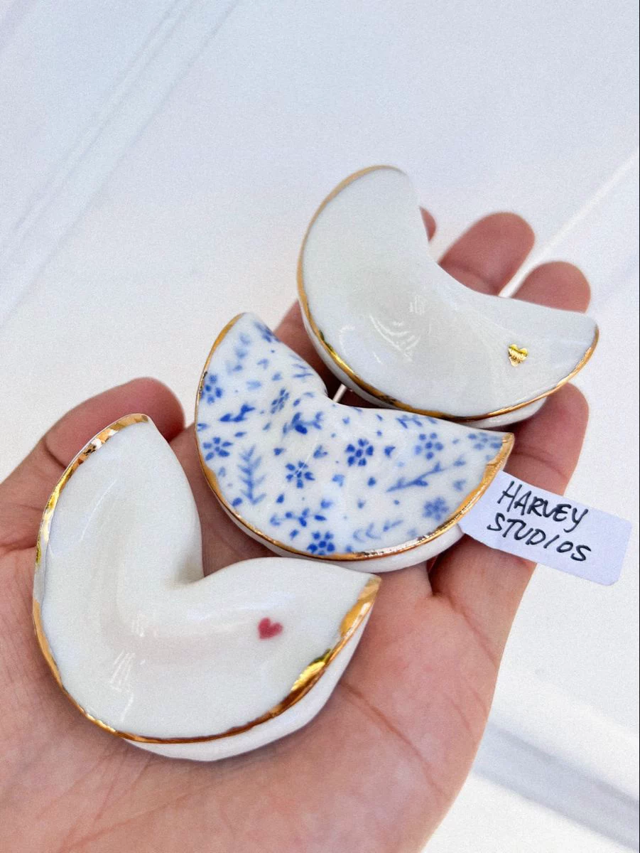 Handmade ceramic moon-shaped trinket dishes with gold edges as wedding favors