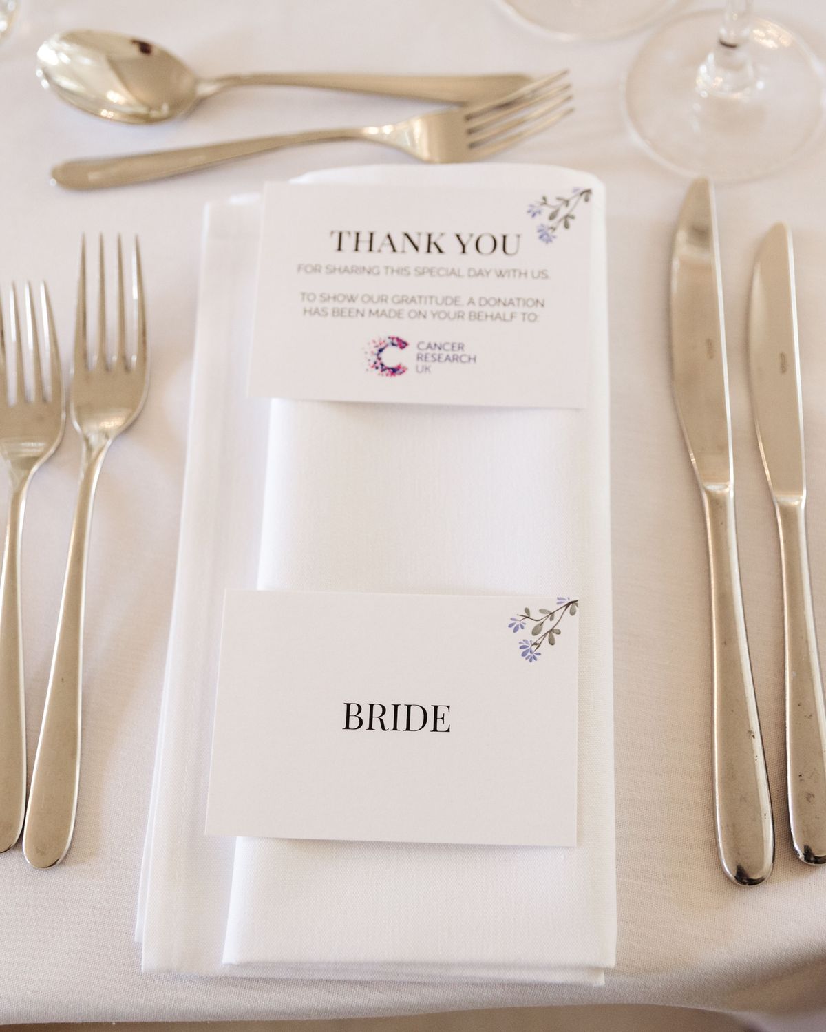 Cancer Research UK charity donation card as wedding favor at place setting