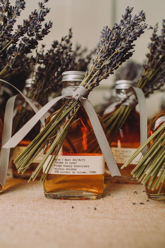 Mini infused oil bottles with lavender sprigs as wedding favors