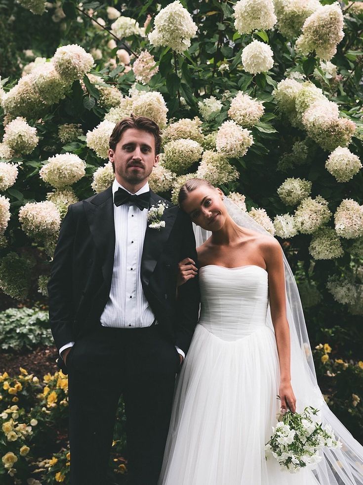 Elegant bride and groom posing in garden for classic mr and mrs quiz