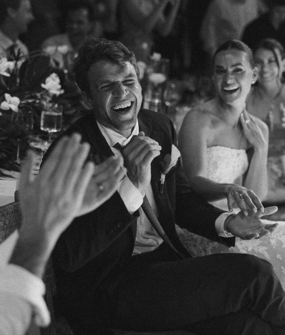 Couple laughing during funny mr and mrs questions at wedding reception