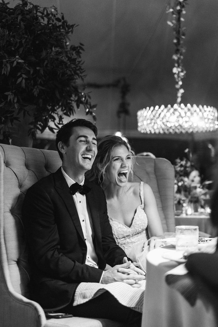 Couple laughing together during who is more likely to mr and mrs game