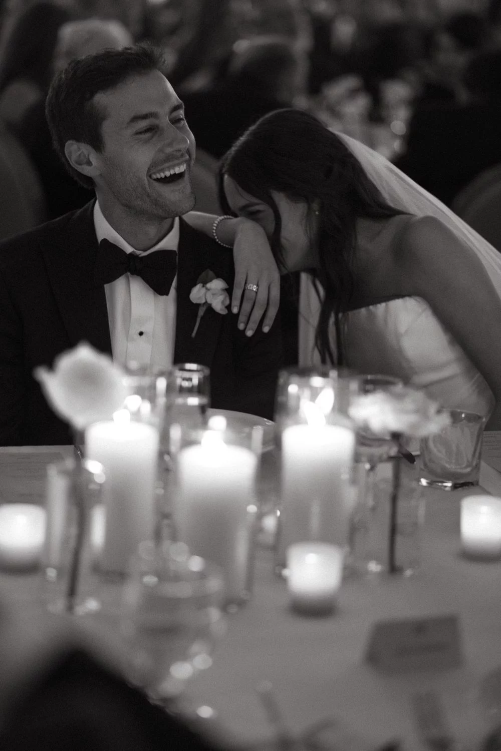 Bride laughing into groom's shoulder during mr and mrs quiz memory round