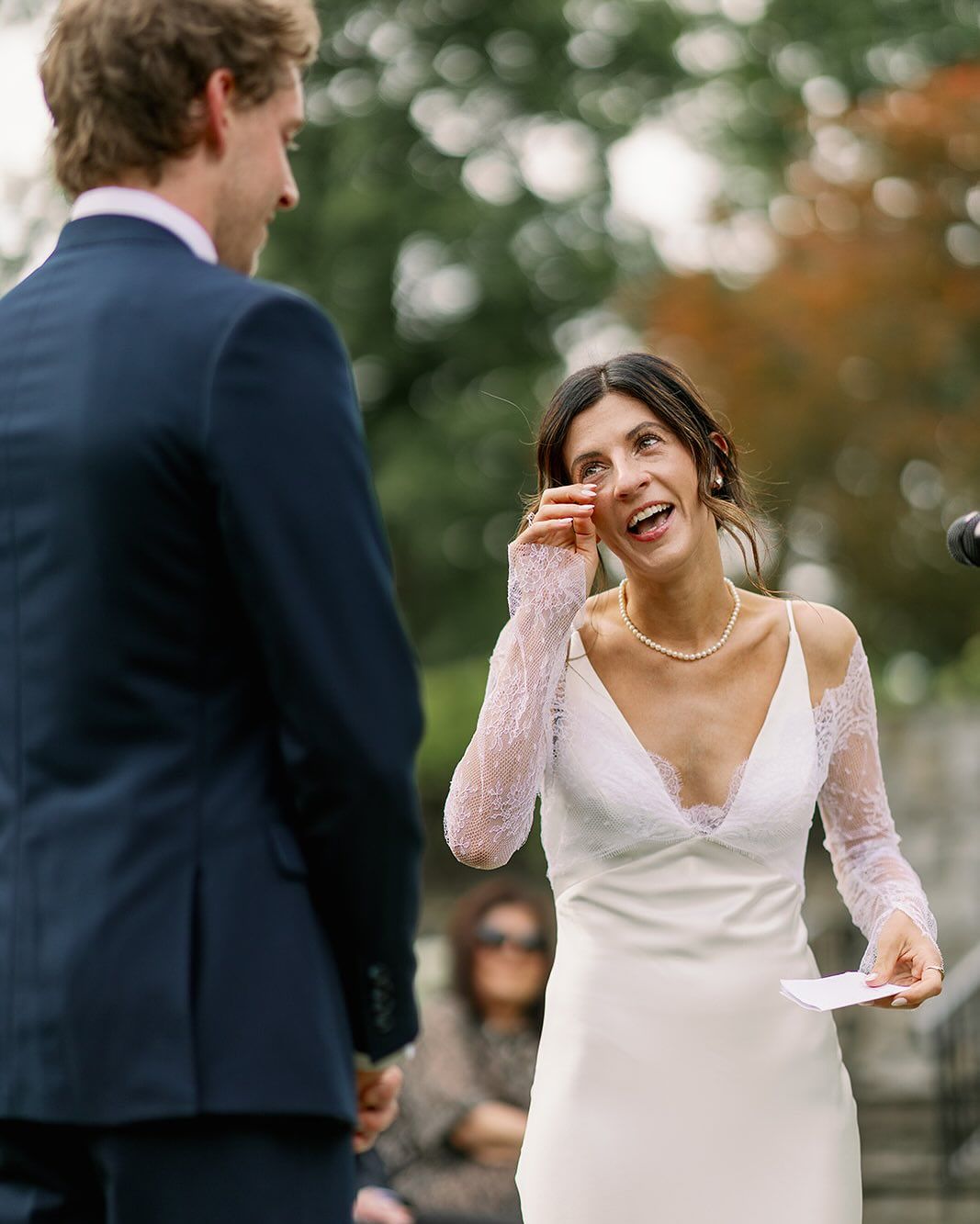 Bride wiping happy tears during sweet and romantic mr and mrs quiz moment