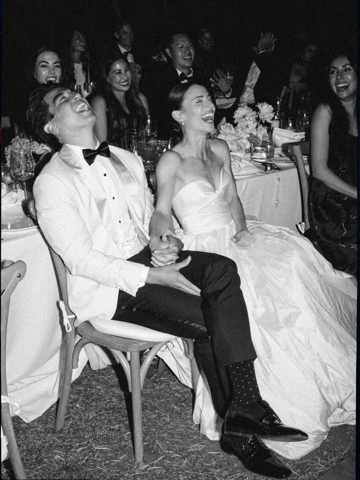 Couple laughing hysterically with guests during this or that mr and mrs quiz round