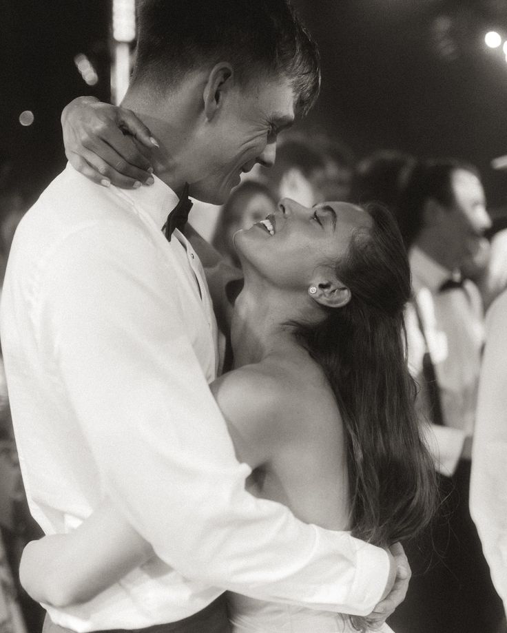 Bride and groom embracing during mr and mrs game at wedding