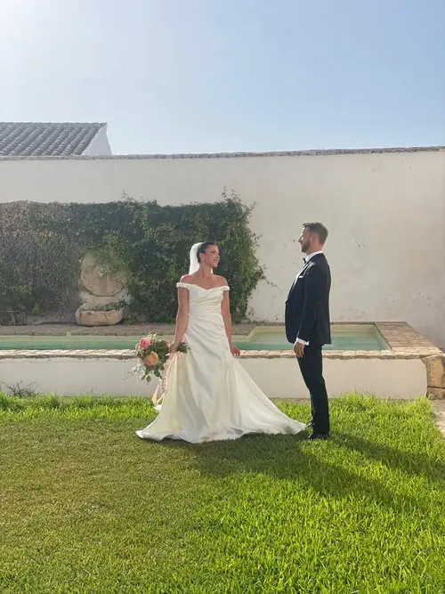 Bride and groom facing each other outdoors